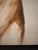 A figure rendered almost entirely in warm sepia and umber washes, the paint pooling and bleeding into the raw canvas...