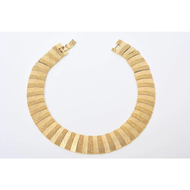 This is part of Chairish’s Costume Jewelry assortment. A combination of brushed and woven gold-plated bar makes this...