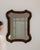 Carved wood scalloped mirror in Rich Walnut Brown. Its rich walnut brown finish sets off ornate scalloped silhouette,...