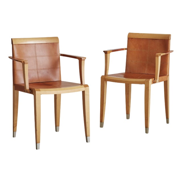 An ‘Aro’ cherry wood and leather armchair designed by Chi Wing Lo for Giorgetti in 1995. This Italian armchair features an...