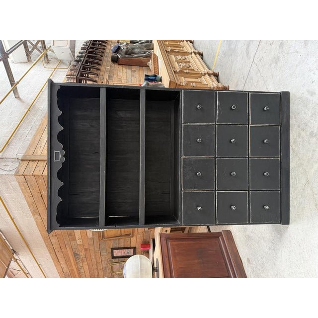 This antique patinated grocer’s cabinet has been fully restored. It features three large shelves and twelve functional...