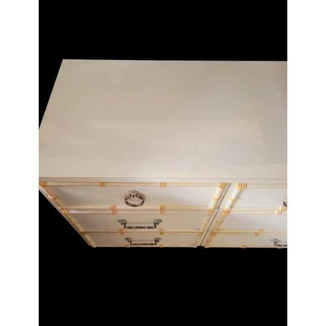 Bring quintessential old Palm Beach Regency to your space with this striking vintage nine-drawer faux bamboo dresser....