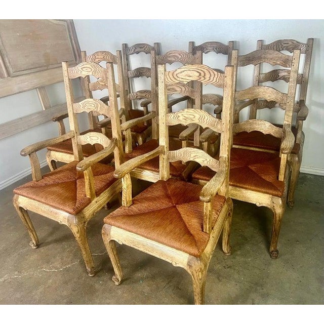 Set of eight French Provincial Ladderback armchairs with rush seats, crafted by Le Monde du Bois, a French furniture...