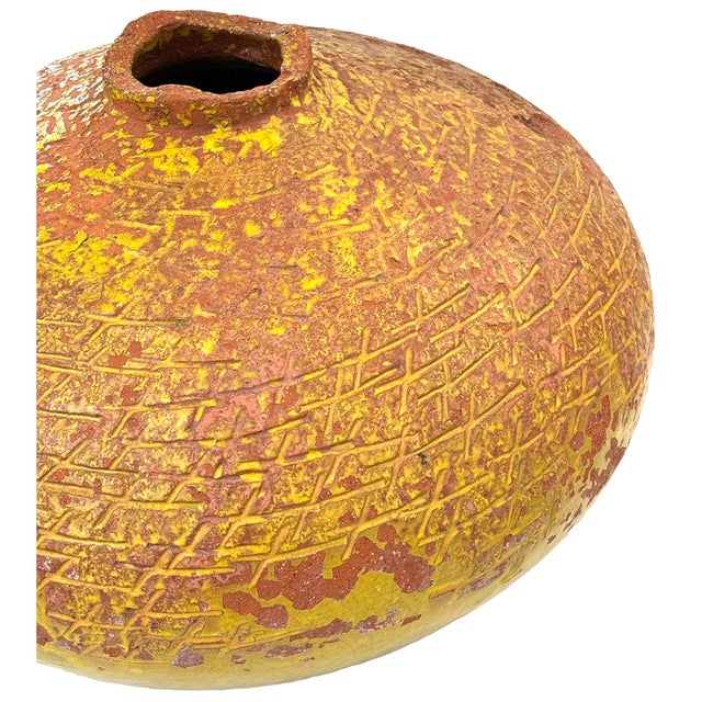 An outstanding large terra cotta vessel with mottled mustard glaze. Monumental scale with graphic sgraffito decoration and...