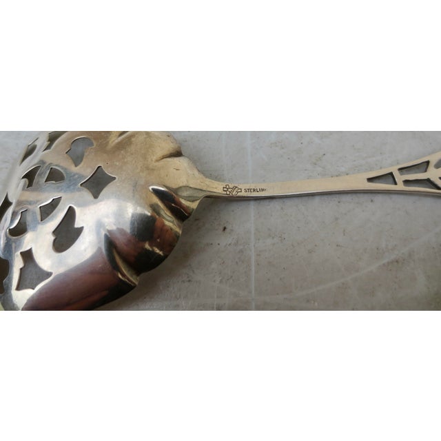 Sterling serving spoon with a pierced bowl. Measurements: 5" by 1.75"; weight: 9.7 Dwt. Manchester Silver Co., circa 1910....