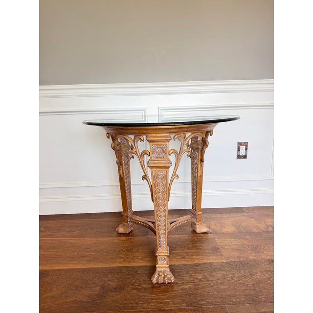 An exceptional vintage cast metal accent table featuring an ornate sculptural base with dramatic Gothic Revival and...