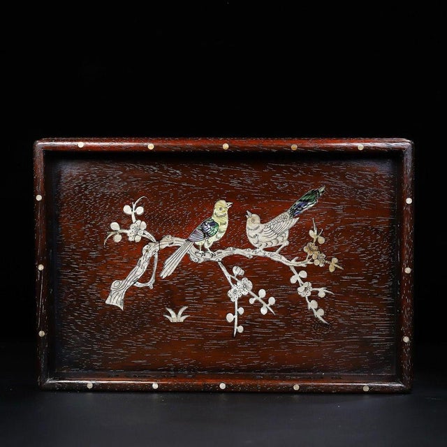 This is a beautifully crafted rectangular wooden tray featuring intricate mother-of-pearl (nacre) inlay work. Crafted from...