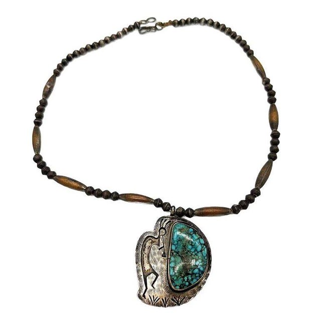 A Navajo Sterling Silver Necklace with a Turquoise stone, this beautiful necklace depicts Kokopelli, a prehistoric...