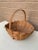A beautifully woven early 20th century American splint oak basket with warm honeyed tones and a tightly constructed...