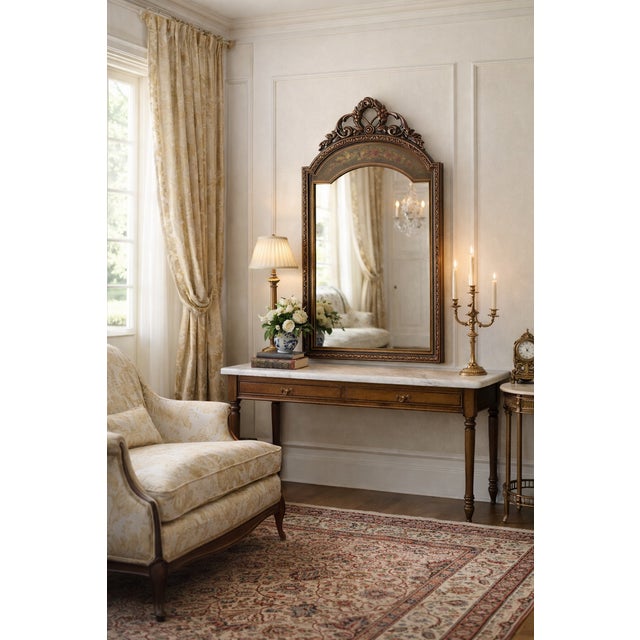 A French Rococo Revival arched mirror featuring a finely carved pierced foliate crest with acanthus scrollwork and floral...