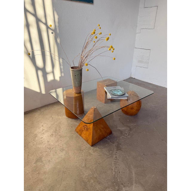 Vintage coffee table with a glass top and four solid elm legs, each in a geometric shape. attributed to metafora, this...
