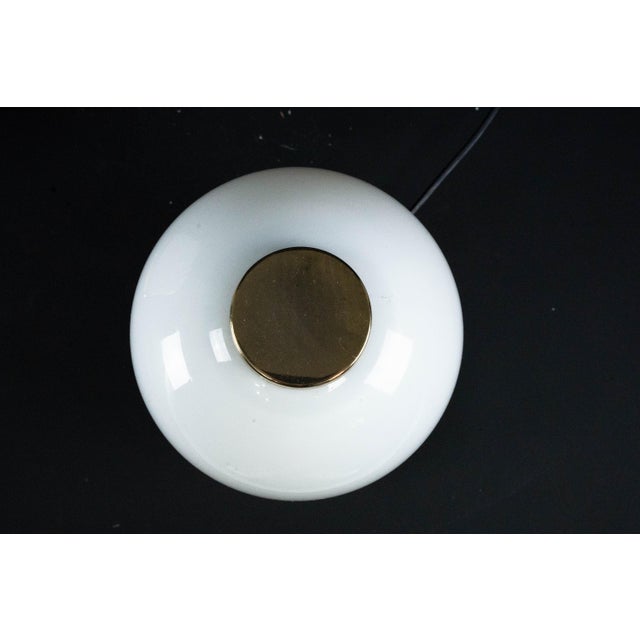 Elegant pair of vintage bedside lamps crafted in Lattimo Murano glass and gilded metal, Italy, 1980s. Each lamp features a...