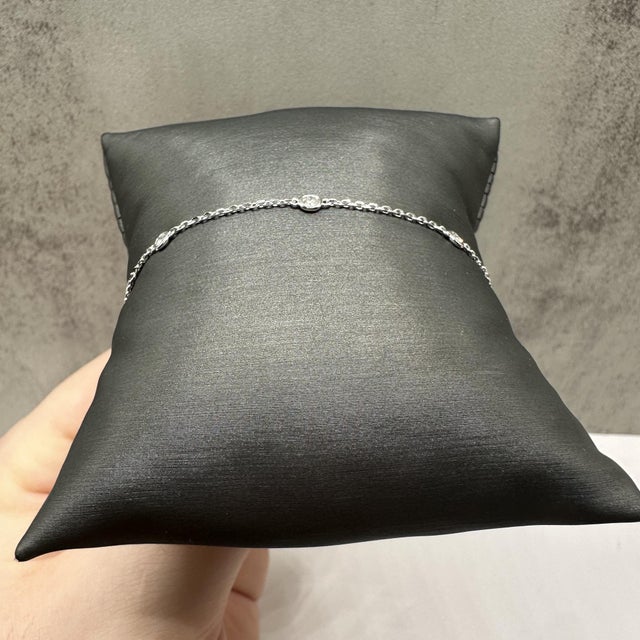 This elegant diamond station bracelet in 14kt white gold features 0.22 carats total weight of natural GH SI2–I1 round...