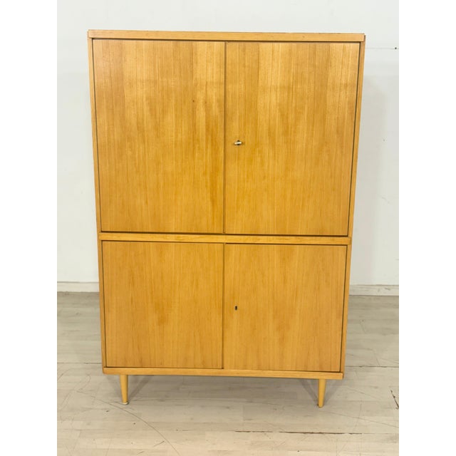 Beautiful, two-door cabinet made of light wood with delicate legs, as seen in the attached pictures. The cabinet impresses...