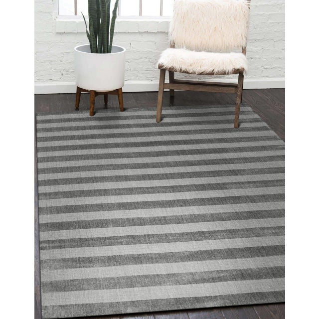 Yara Alluring Gray Handmade Wool Rug, Country of Origin: India. This exceptional piece presents a striking, contemporary...