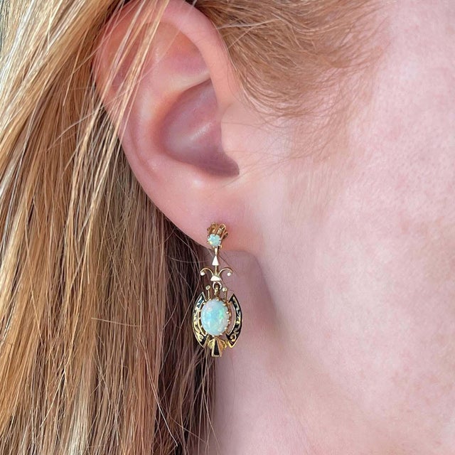 Transport yourself to the grandeur of the American Victorian era with these elegant Opal earrings. These exquisite pieces...