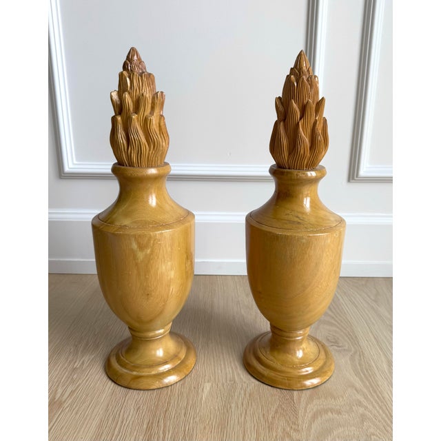 A unique pair of handcrafted turned wood urns with a distinctive blend of classical form and sculptural artistry....