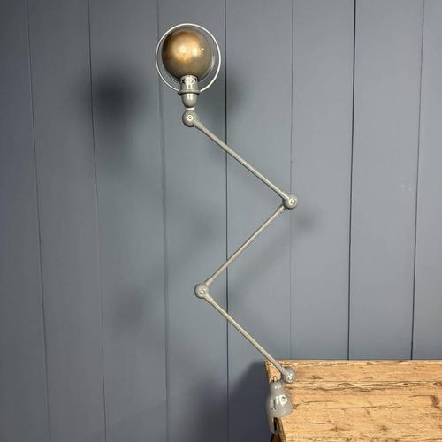 Dark grey 3-arm Jieldé table clamp lamp. Designed by the French engineer Jean-Louis Domecq in the 1950s. He devised a...