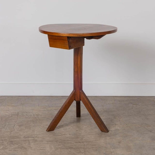 Beautiful wood pedestal table from France, 1950s. Circular wood top with drawer on carved stem on a tripod base. Original...