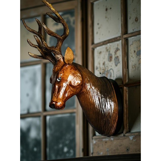 This is a handcrafted deer head wall mount sculpture, made from materials such as wood, leather, or paper mache. The...