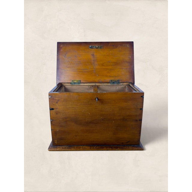 A charming antique English oak tea caddy dating to circa 1900. Beautifully simple in form, this piece features warm oak...