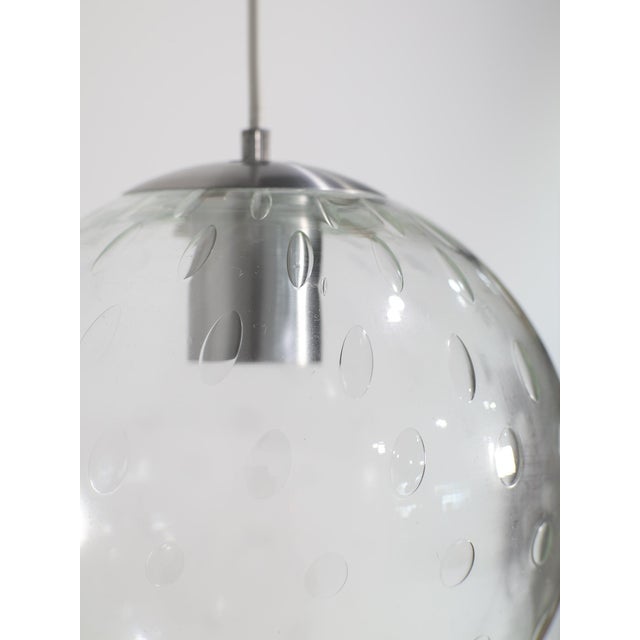 Beautiful glass globe lamp produced by RAAK Amsterdam, 1960s / 1970s. This globe pendant lamp is made of hand-blown clear...