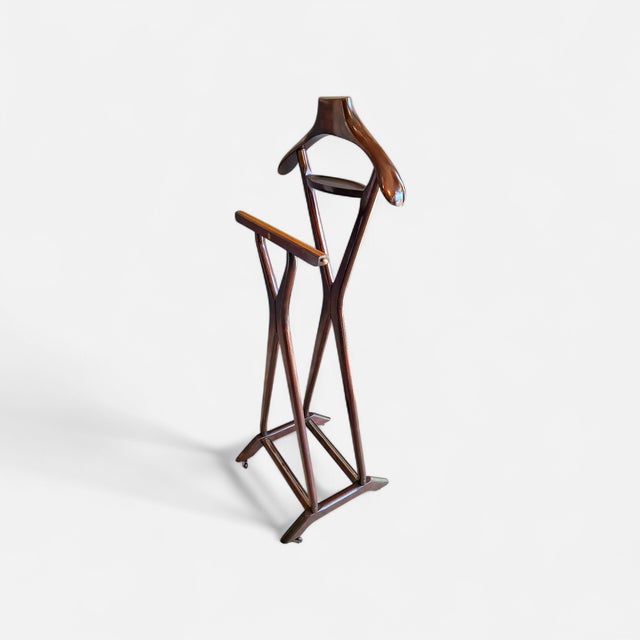 Stained wood valet stand with brass details, made in the 1960s by FRATELLI REGUITTI. The company also collaborated with...