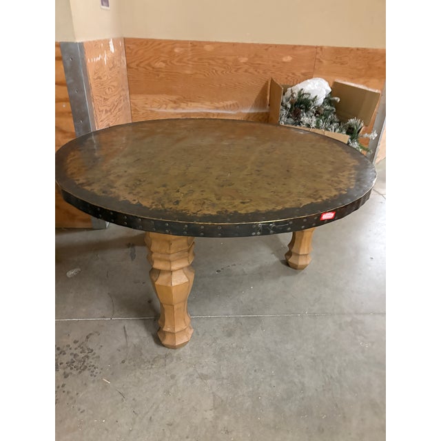 Hammered Brass Top table 5’ wide 3’ tall. Wooden legs. Heavy piece. No make or model or vendor known, but it did have the...