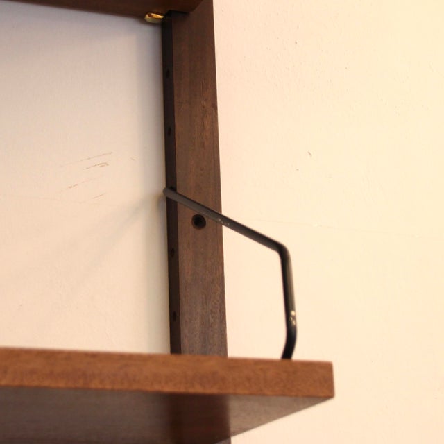 Royal System shelving unit in teak and American walnut, designed by Poul Cadovius of Denmark in the 1960s. The two...
