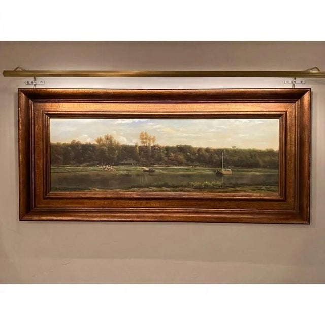 This charming mid-20th-century oil painting by M. Gester captures a serene river or lakeside landscape. The panoramic...