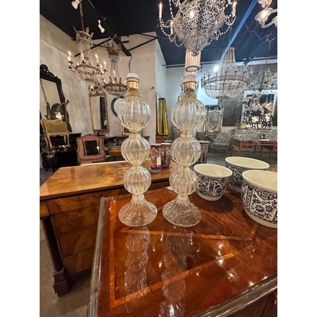 Elegant pair of modern gold Murano glass ball form lamps. Featuring beautiful textured glistening glass. Makes an...