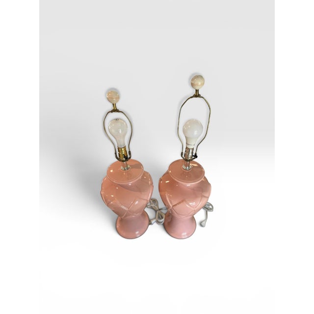 A delightful pair of vintage ceramic table lamps featuring a glossy blush pink glaze and elegant diamond-pattern relief...