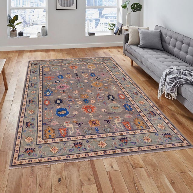 Enhance the ambiance of your home with this magnificent Persian-influenced Turkish hand-knotted rug made by skilled...