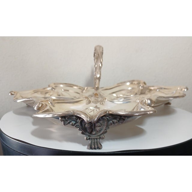 A stunning Art Nouveau silver plate serving dish, crafted between 1890-1910. The intricate design of the dish reflects the...