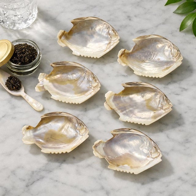 Set of six hand-made, genuine mother‑of‑pearl bowls carved in a stylized fish form, each with luminous natural iridescence...