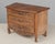 A Louis XV style French miniature sample chest made of solid walnut with serpentine front and three dovetailed drawers....
