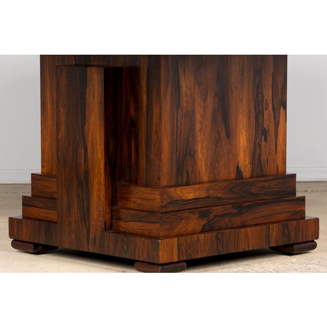 A striking 1930s French Art Deco square dining table, sourced in Paris, France, featuring richly figured rosewood veneer...