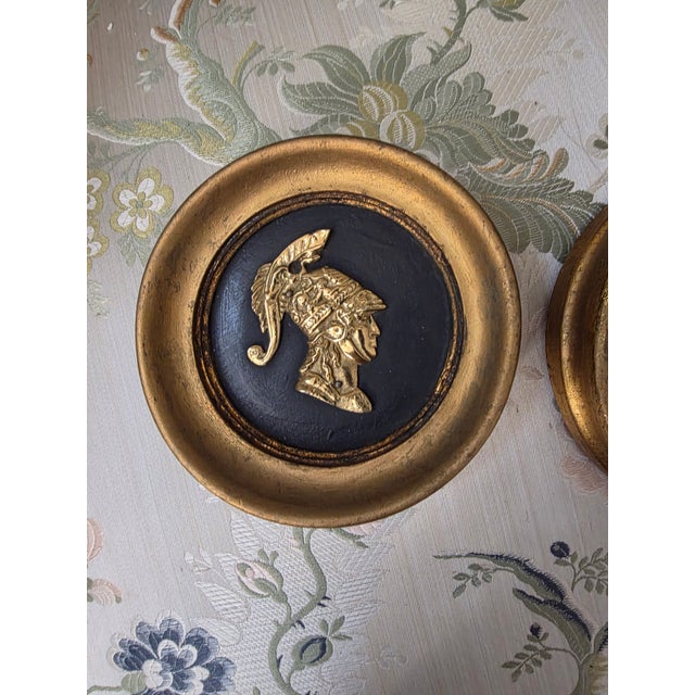 Two Cast plaster and brass helmet profile Italian wall plaques.