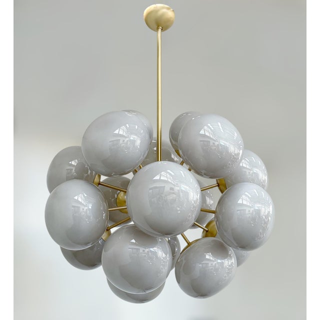 Italian oval shaped chandelier with gray Murano pebble glass shades mounted on brass frame in satin brass finish / Made in...