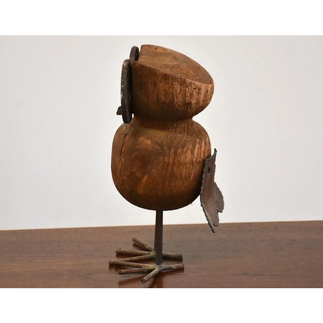This owl sculpture is constructed of wood and steel with acute abstract details 4.75” wide. 5.5” deep. 10.75” tall.