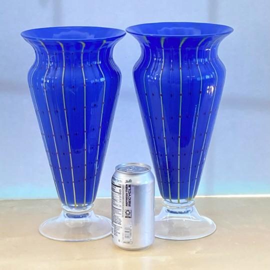 A stunning pair of vintage post-modern Italian art glass vases in the style of Murano. The vases are handblown and feature...