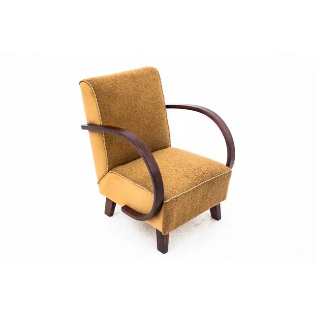 An iconic armchair designed by J. Halabala in the Art Deco style, made around 1930. The seat and backrest are upholstered...