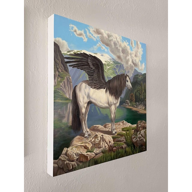 This oil painting depicts a majestic winged horse standing on a rocky outcrop, surrounded by a serene landscape of...