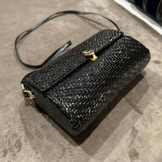 This Italian vintage shoulder bag is a striking blend of elegant texture and mid-century charm, combining traditional...