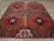 A wool pile of symmetric knots on a wool foundation. This striking rustic carpet shows a rust-red field with a decoration...