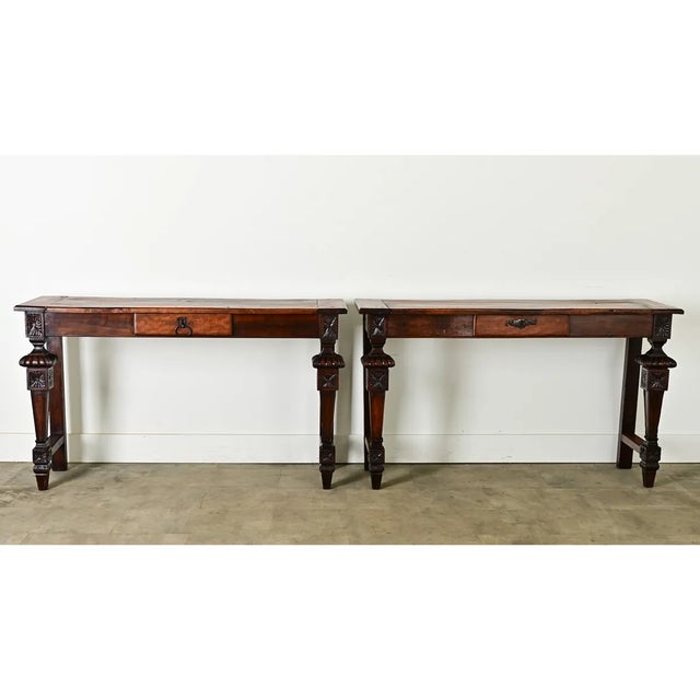 Dimensions: 32” H x 53 ⅞” W x 16 ½” D A handsome pair of Louis XVI console tables, 1800s France, crafted from solid...