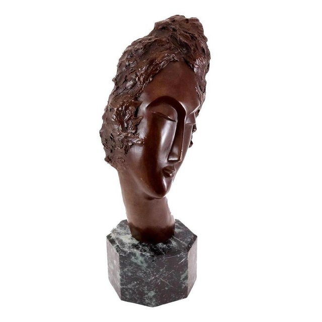 Art Deco style brown patinated bronze woman’s head sculpture from the 20th century. This modern bronze sculpture...