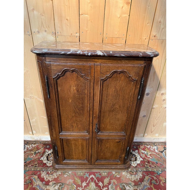 Small two-door wardrobe in solid oak, early 19th century, in the Louis XIV style. Simple architecture with a plinth and...