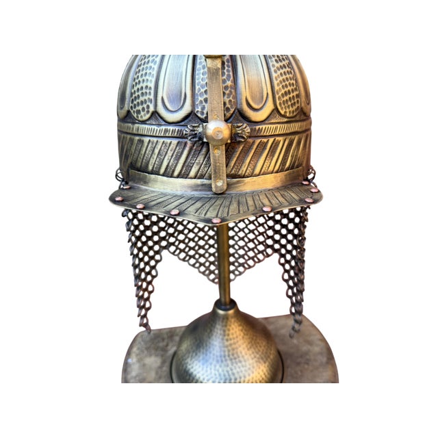 Designed to anchor a distinguished workspace or a curated library shelf, this handcrafted brass helmet brings the weight...