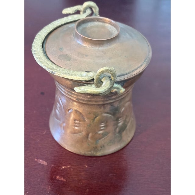 This 19th century fire cauldron with lid is hand hammered and has a brass handle.